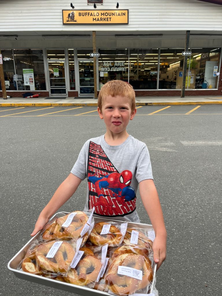 Child holding Buffalo Mountain Market delivery