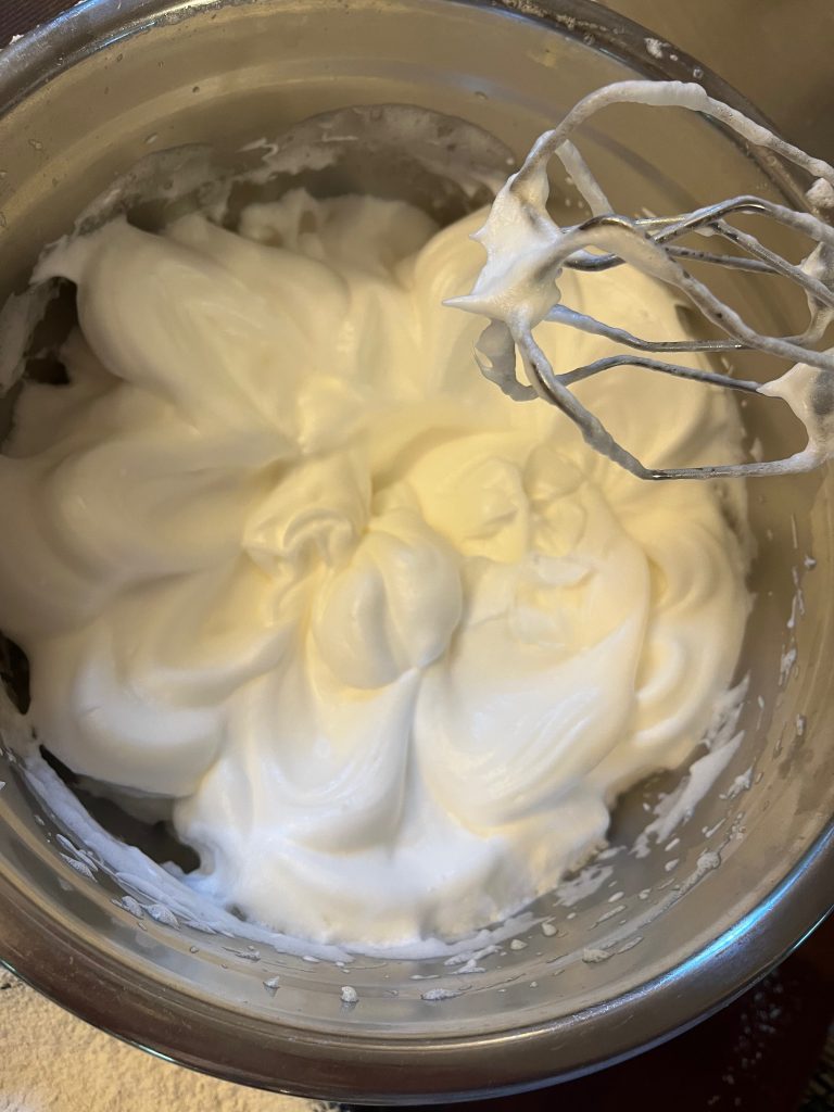 meringue in bowl with whisks