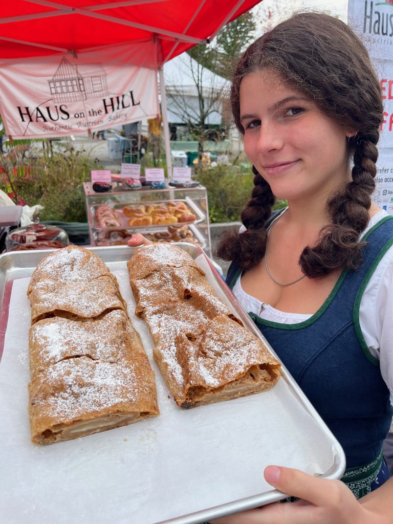 girl with apple strudel in tradtitional Austrian dress